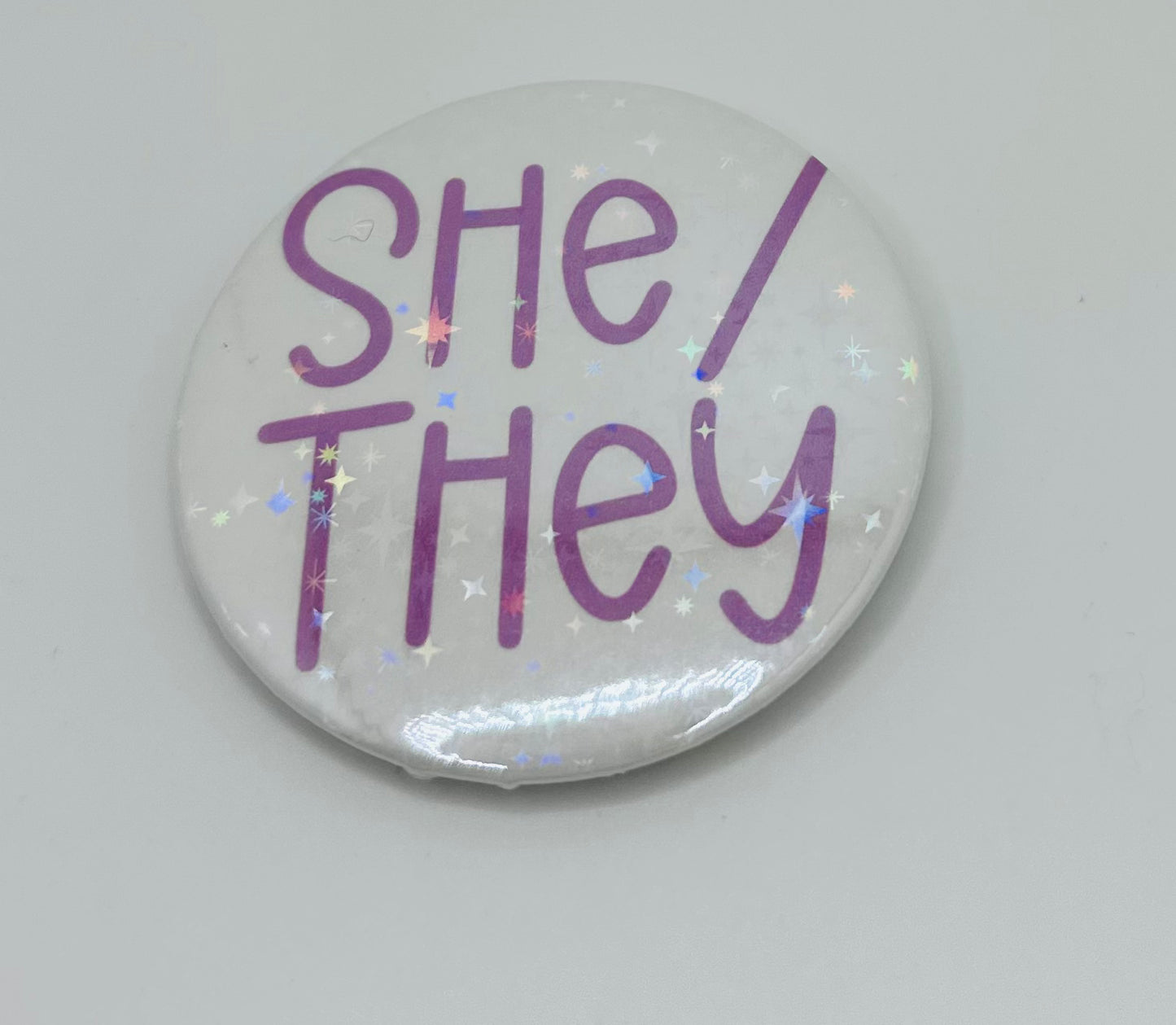 Holographic She/They Pronoun Buttons